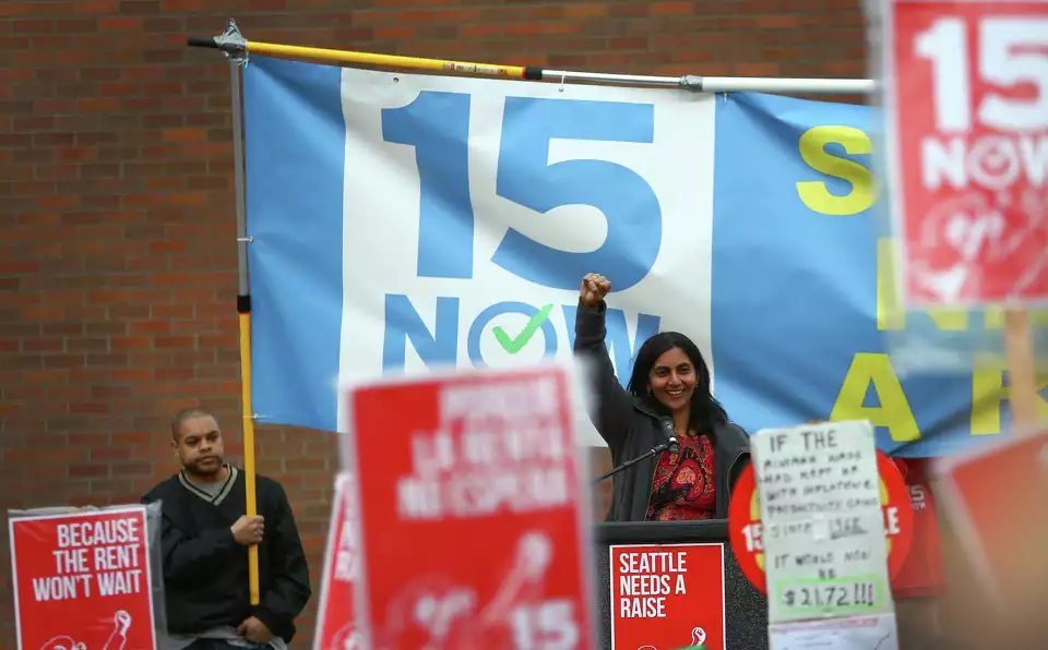 15-now Kshama Sawant raises her fist victoriously at a 15 Now rally